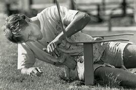 Jason Adrian is painting new bench seats at Rocky Point Marina