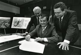 Mayor Lou Sekora signing a document