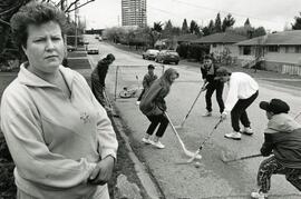 Mary Kent with kids playing street hockey