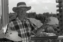 Photo of Dr. Heffelfinger posing with his hats for a feature on the groups and associations he is a member of