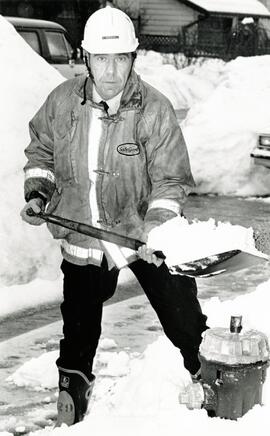 Fire Prevention Officer Larry Pierce clears snow from hydrant on Sechelt Crescent in Coquitlam