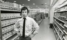 Man posing in front of hair dye shelves