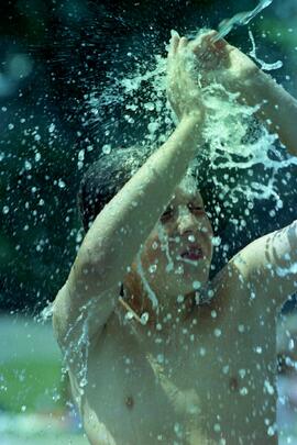 Michael Baron getting splashed with water at the Blue Mountain spray park