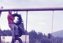 Man on a tire swing
