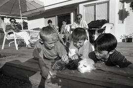 Andre and Anton playing with John Walker and guinea pigs