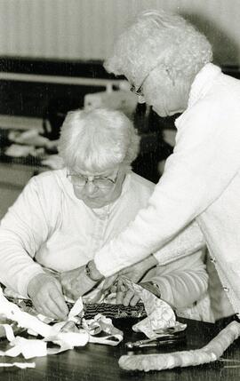 Kaye Paquette (sitting) and Ella Wheeler work on crafts at the Kyle Centre Monday in preparation for the upcoming bake and craft sale Nov. 2.