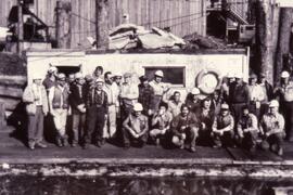 Group of work men at a mill