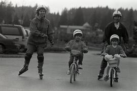 Pam and Steve Campbell on rollerblades keeping up with their kids on bikes at Coquitlam town centre parking lot.