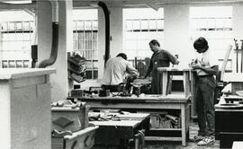 Staff and inmate at work in one of the shops.