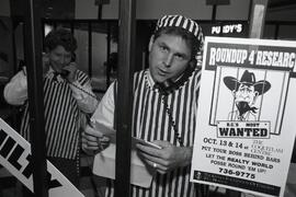 Barry Fretta, Greg MacKinnon and Vicki Henderson behind bars at Kidney Foundation fund raiser at Coquitlam Centre.