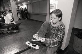 Donnie Poland laces his skates at Coquitlam Rec Centre