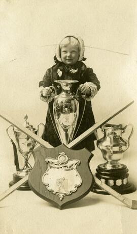 Child holding a hockey trophy