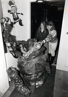 Marnie Kurylo (l.) and Anne Millerd (r.) admire Christmas paper mache decorations