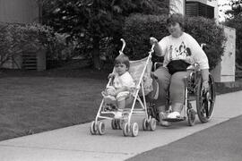 James Doriech many not notice the difference but his mother Susan sure does as she handles both her wheelchair and the stroller along Wilson St.