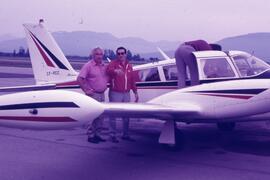 Mel Earl and D. Filipillie standing in front of an airplane