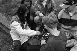 Kids building shelters and learning survival techniques at Kilmer Elementary