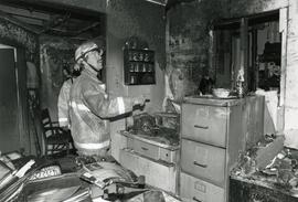 Firefighter Ron Bourassa investigates fire