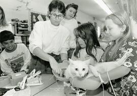 Morgan Young (right) and her partner Lindsay Bardua get some help from teacher Mary Ringwald weighing Morgan's cat Holly at Westwood Elementary School.