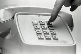 Finger about to touch button on phone