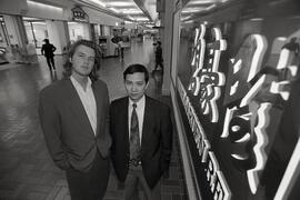 Raymond Leung and Russ Davis chat with James Cheung, owner of Multiway Restaurant and Bakery, in Westwood Mall. Mall is going after Asian market.