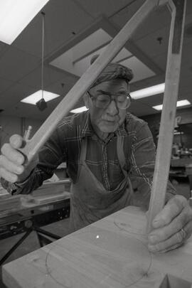 73-year old Harold Gent measuring the wheels for a wagon he is building at the Dogwood Pavilion woodshop