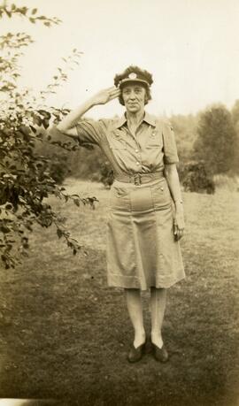 Ida May Headridge standing and saluting in uniform