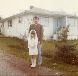 Roger and Audrey Champagne in front of their house