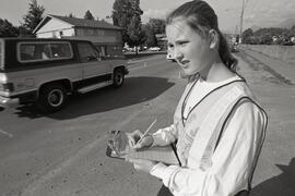 Nadine Shinkaruk, a Grade 9 student at Mary Hill Junior Secondary, counts passing cars with seatbelted drivers as part of safety effort at school