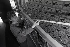 Vicki Donahue measures the success of donation wall at Port Moody