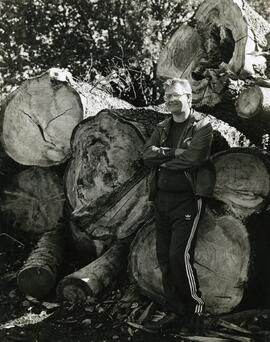 Man with cut down trees
