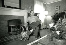 Man in a rocking chair with a cocker spaniel
