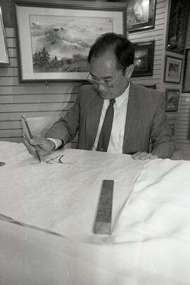 Artist Yu Ting showing off his work at The Art Company in Coquitlam Centre