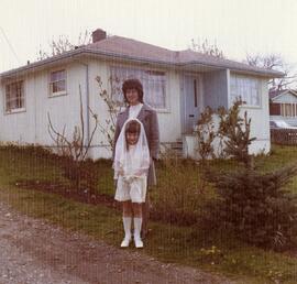 Cécile and Audrey Champagne in front of their house