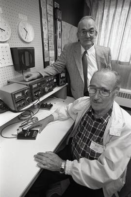 Official opening of the Coquitlam Senior Amateur Radio Emergency Service Society at Riverview Hospital with president Ed Calderwood and member at large Gordon Penwill with a transeiver