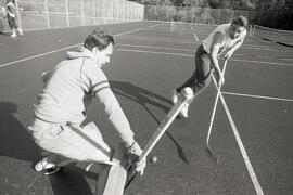 News staff playing street hockey