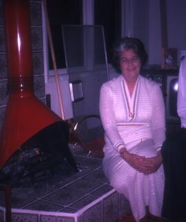 Nina Seller standing in front of the fireplace