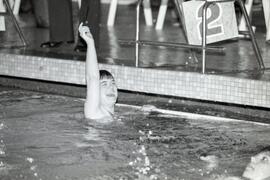 Special Olympics swimming at Chimo Pool. Coquitlam Invitational. Crystal Diamond raising hand in air after winning 1st heat in the 50 meter backstroke...