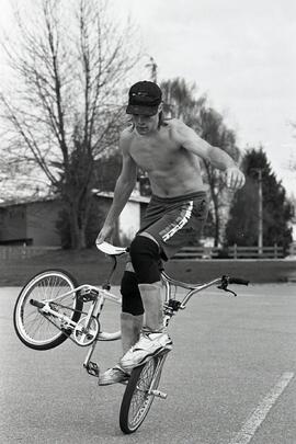 Riding freestyle B.M.X. at Coquitlam Sports Centre parking lot