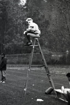 Adrien Hooper, football player on a ladder at Hastings Jr. Secondary