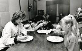 Amanda Coulter and kids Fred and Alexis sitting down to dinner maybe for the last time