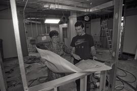 Administrative officer Betty Thomas and CDC Construction foreman Graeme Grant reviewing renovation plans for the radio room at the Coquitlam RCMP