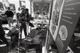 Stand alone photo of people looking through some of the items on sale at the United Way garage sale at The Royal Bank at Coq Town Centre