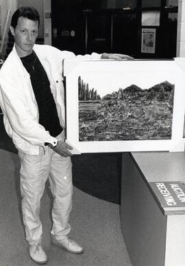 Coquitlam artist, David Patterson, is shown with his framed monotype print