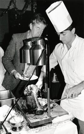 Lighthouse employee Andy Abenthung slices a piece of roast beef for Harry Schmidt during seniors brunch