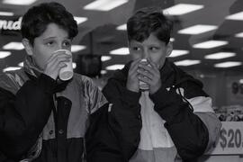 Aaron Callihoo and Mark Ruggieri enjoy a cup of coffee outside the MegaMove giant video sale on Lougheed and Westwood