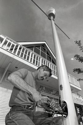 Rick Daurie of Transwestern Electric installing one of several decorative streetlamps on Saint John's Street in Port Moody