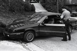 High Speed pursuit car chase ending in escape of youth in Port Moody. Photo of car and police officer.