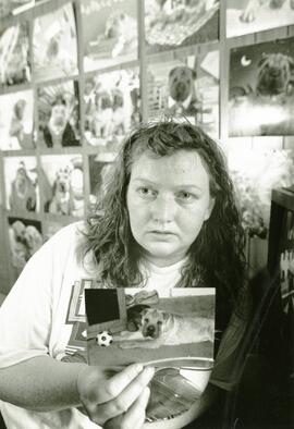 Cheryl LaFrance with pic of her stolen dog, Clyde.