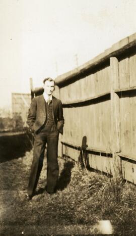 Maurice Benson next to a fence