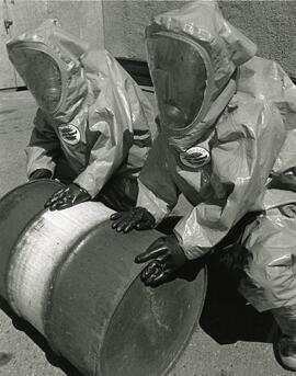 Port Coq. Fire Dept recruits Jeff Sweet and Pat Curly try working (for the first time) in chemical protective suits